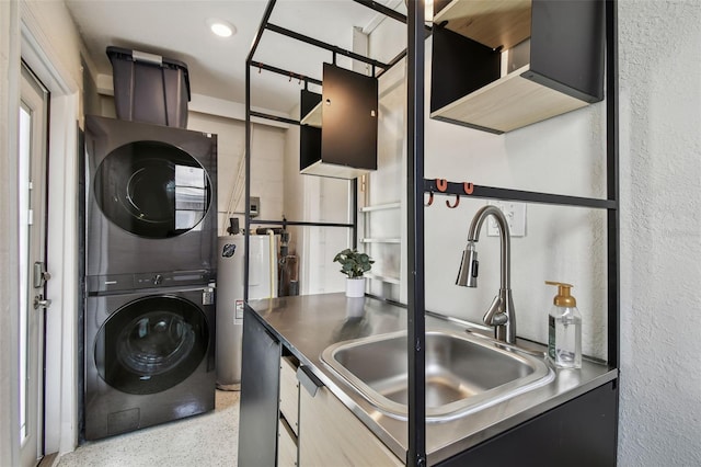 washroom featuring estacked washer and dryer, water heater, and a textured wall