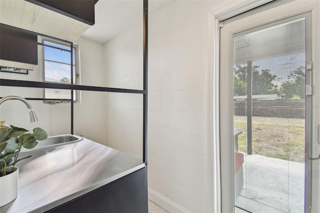 bathroom featuring a sink and baseboards