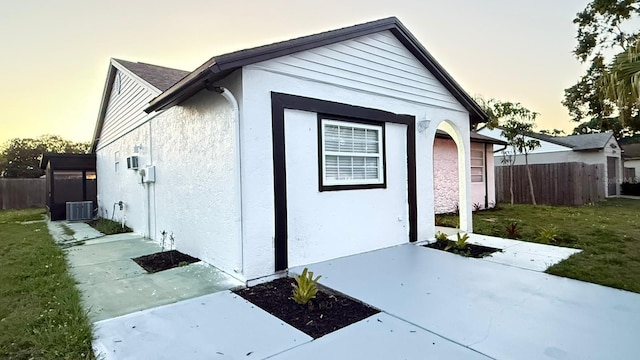 3145 Munson St, New Port Richey, FL 34655 - view of property exterior featuring stucco siding, a patio area, and central AC unit