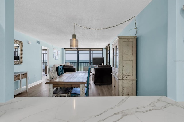 15400 Gulf Blvd Unit 202, Madeira Beach, FL 33708 - bedroom with baseboards, a textured ceiling, and wood finished floors