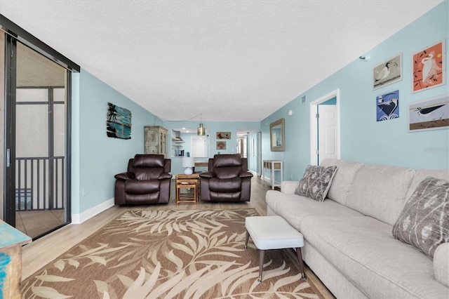 15400 Gulf Blvd Unit 202, Madeira Beach, FL 33708 - living room with a textured ceiling, baseboards, visible vents, and wood finished floors