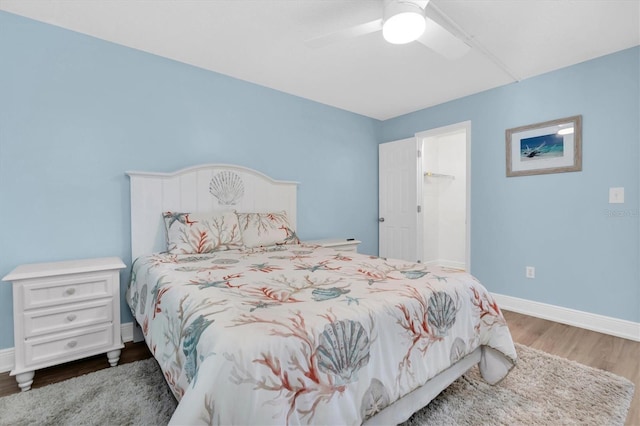 15400 Gulf Blvd Unit 202, Madeira Beach, FL 33708 - bedroom with baseboards, a ceiling fan, and wood finished floors