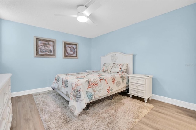 15400 Gulf Blvd Unit 202, Madeira Beach, FL 33708 - bedroom featuring a ceiling fan, baseboards, and light wood-type flooring