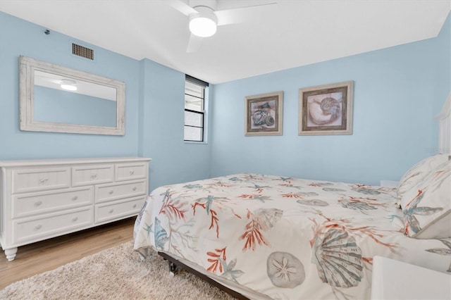 15400 Gulf Blvd Unit 202, Madeira Beach, FL 33708 - bedroom featuring visible vents, a ceiling fan, and wood finished floors