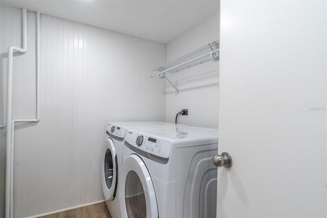 15400 Gulf Blvd Unit 202, Madeira Beach, FL 33708 - laundry room with laundry area, washing machine and dryer, and wood finished floors