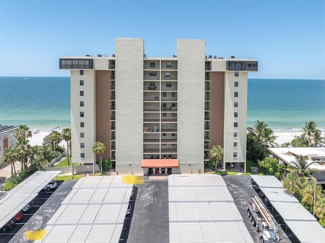 15400 Gulf Blvd Unit 202, Madeira Beach, FL 33708 - view of property featuring a water view, uncovered parking, and a view of the beach