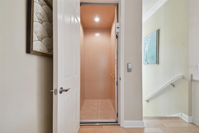 corridor featuring crown molding, recessed lighting, elevator, and baseboards