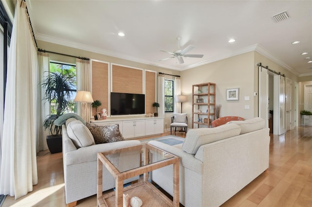 living room with recessed lighting, a barn door, plenty of natural light, and ceiling fan