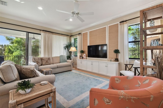 living area featuring a ceiling fan, visible vents, a wealth of natural light, and recessed lighting