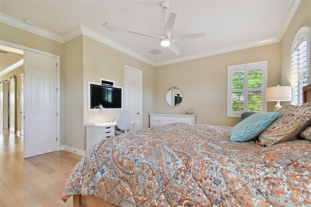 bedroom featuring baseboards, ornamental molding, light wood finished floors, and visible vents