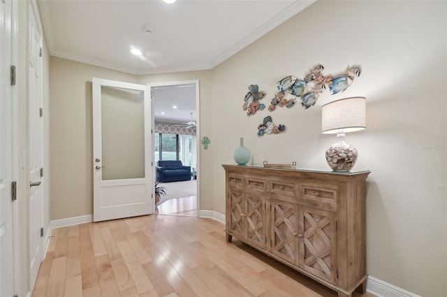 hall with light wood-type flooring, recessed lighting, baseboards, and ornamental molding