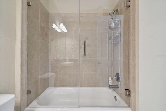 full bath with enclosed tub / shower combo and toilet