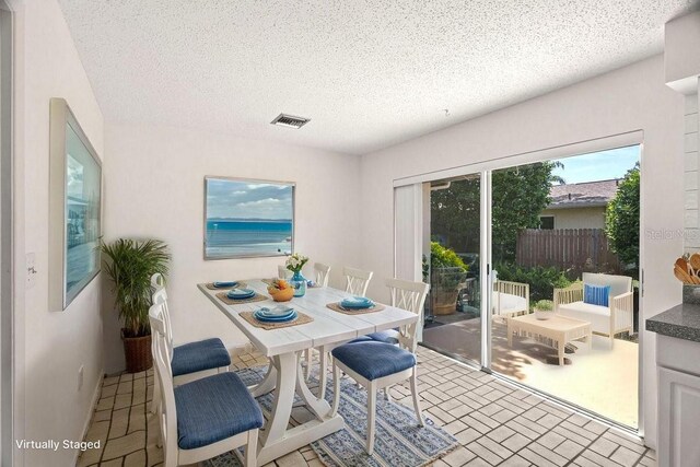 dining area featuring a textured ceiling