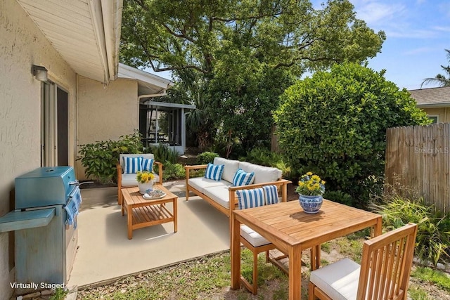 view of patio / terrace featuring an outdoor hangout area, fence, and a grill