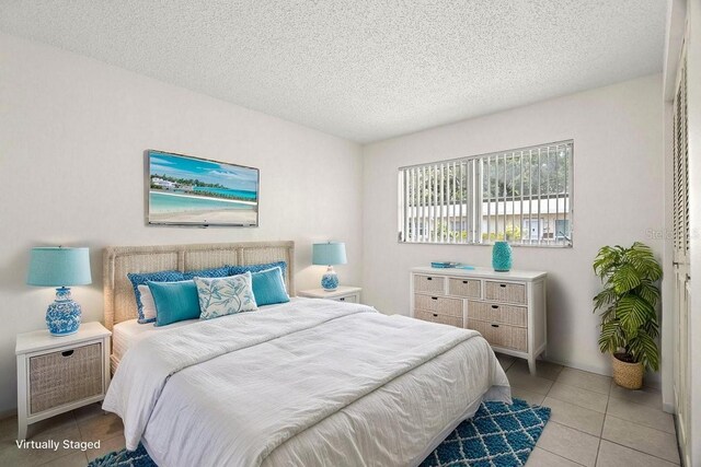 bedroom featuring tile patterned floors and a textured ceiling