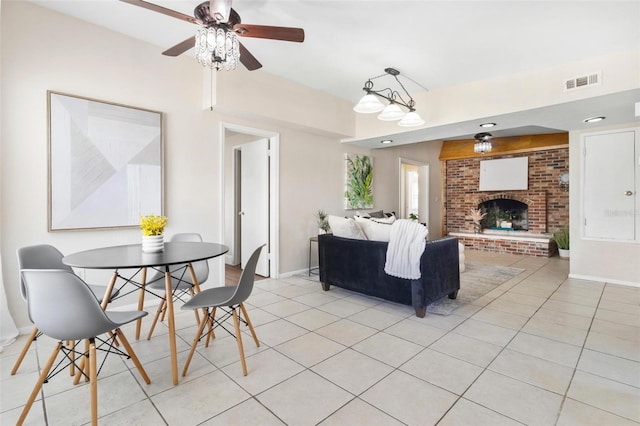 8184 Rose Ter, Seminole, FL 33777 - living room featuring visible vents, a ceiling fan, light tile patterned floors, baseboards, and a brick fireplace