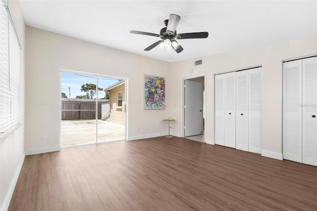 8184 Rose Ter, Seminole, FL 33777 - unfurnished bedroom with visible vents, baseboards, a ceiling fan, wood finished floors, and multiple closets
