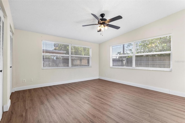 8184 Rose Ter, Seminole, FL 33777 - unfurnished bedroom with lofted ceiling, wood finished floors, and multiple windows