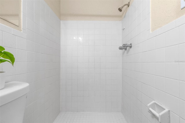 8184 Rose Ter, Seminole, FL 33777 - bathroom featuring a tile shower, tile walls, and toilet