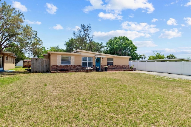 8184 Rose Ter, Seminole, FL 33777 - view of front of home featuring fence, brick siding, and a front yard