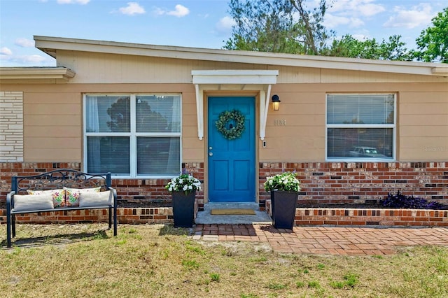8184 Rose Ter, Seminole, FL 33777 - property entrance featuring brick siding and a yard