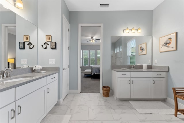 full bathroom with marble finish flooring, baseboards, two vanities, a ceiling fan, and ensuite bathroom