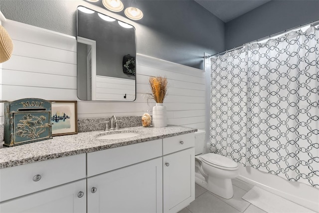 bathroom with tile patterned flooring, vanity, toilet, and shower / tub combo