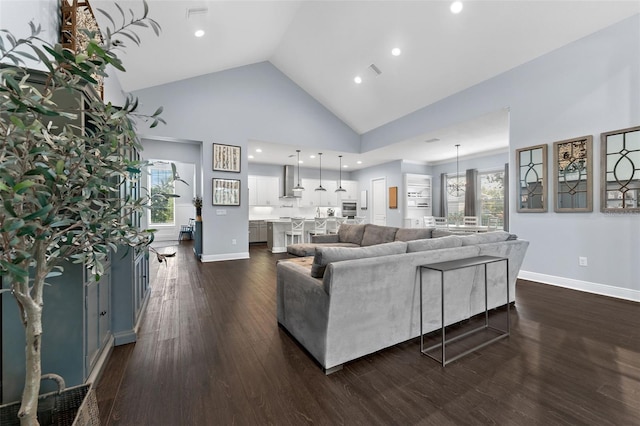 living room featuring high vaulted ceiling, dark wood-type flooring, recessed lighting, and baseboards