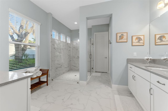 bathroom featuring marble look tile flooring, a marble finish shower, baseboards, vanity, and recessed lighting