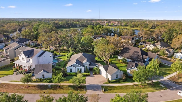 aerial view of residential area featuring a forest