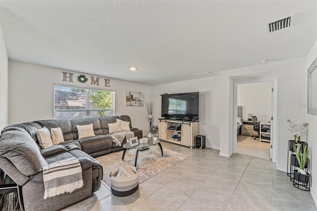 10463 Baylor Dr, Spring Hill, FL 34608 - living room featuring a textured ceiling, visible vents, and light tile patterned floors