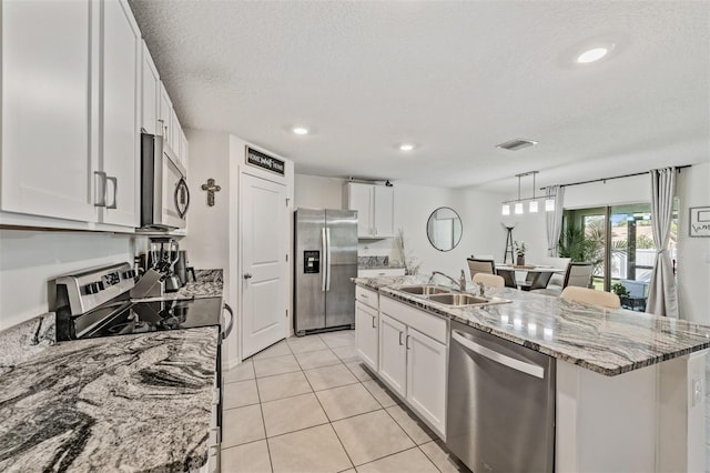 10463 Baylor Dr, Spring Hill, FL 34608 - kitchen featuring white cabinets, appliances with stainless steel finishes, a sink, and visible vents