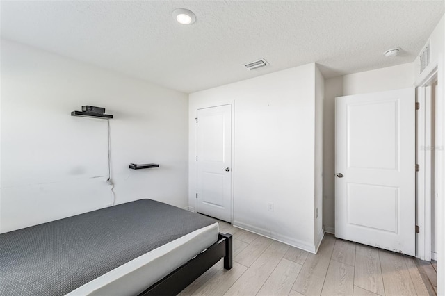 10463 Baylor Dr, Spring Hill, FL 34608 - unfurnished bedroom with light wood-style flooring, visible vents, and a textured ceiling