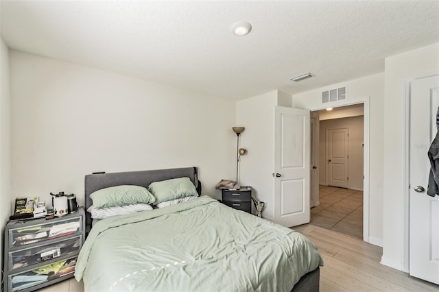 10463 Baylor Dr, Spring Hill, FL 34608 - bedroom with baseboards, light wood finished floors, and visible vents