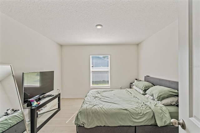 10463 Baylor Dr, Spring Hill, FL 34608 - bedroom with light wood-style flooring and a textured ceiling