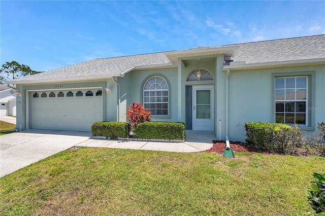 single story home featuring an attached garage, stucco siding, a front yard, and concrete driveway