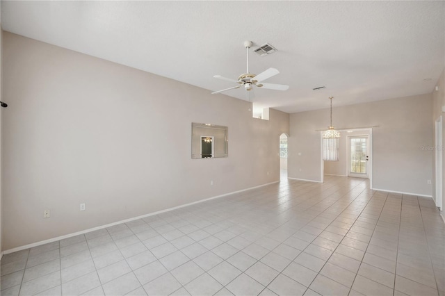 unfurnished room featuring visible vents, arched walkways, baseboards, and a ceiling fan