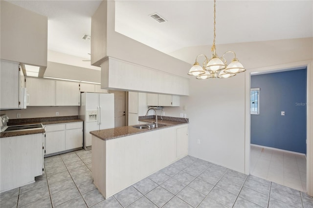kitchen with visible vents, an inviting chandelier, a peninsula, white appliances, and a sink