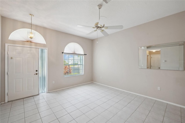 foyer entrance with baseboards, ceiling fan, and light tile patterned floors