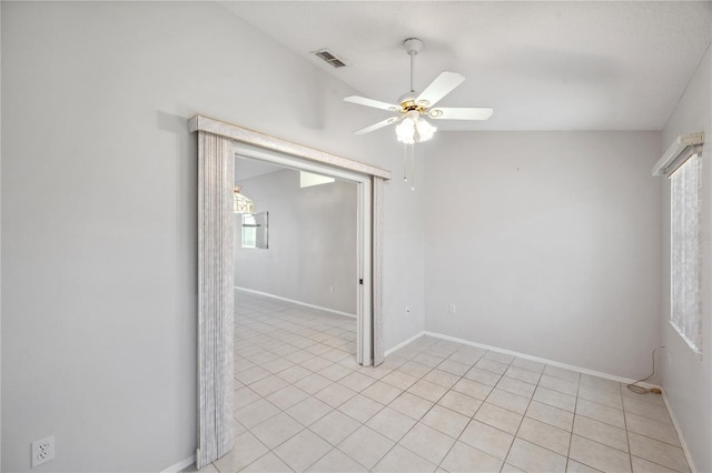 empty room with a ceiling fan, baseboards, visible vents, and light tile patterned floors