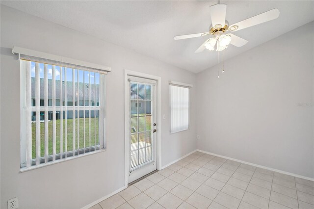 doorway to outside featuring baseboards, ceiling fan, and light tile patterned flooring