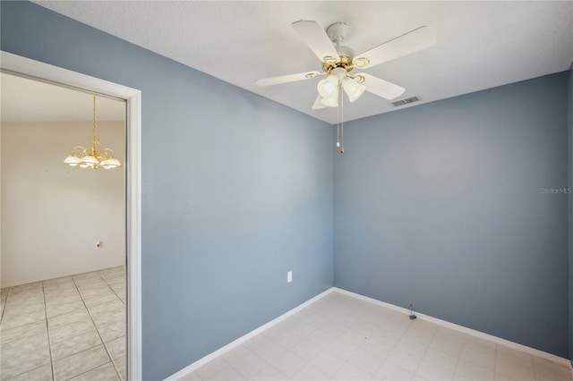 spare room featuring visible vents and ceiling fan with notable chandelier