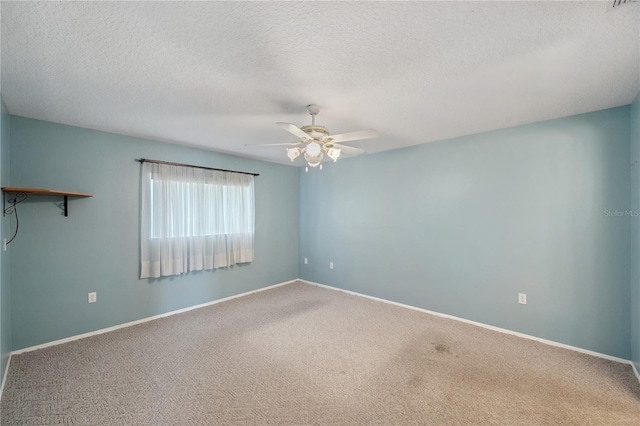 unfurnished room featuring a ceiling fan, a textured ceiling, baseboards, and carpet