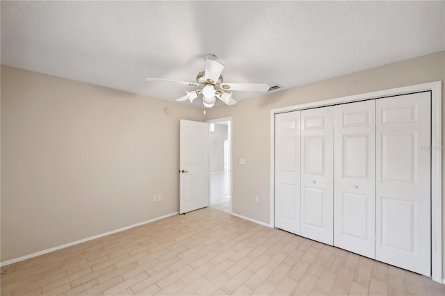 unfurnished bedroom with a ceiling fan, baseboards, visible vents, and a closet