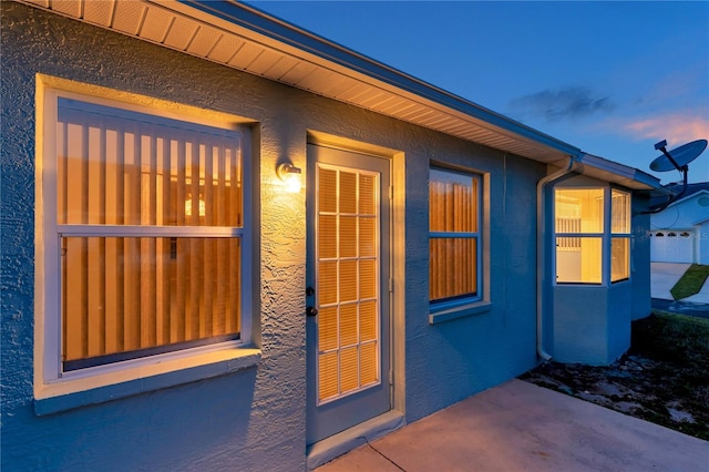 entrance to property with stucco siding
