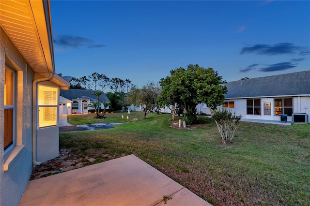 view of yard with a patio and central AC unit