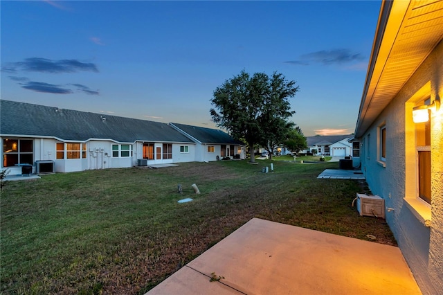 view of yard featuring a patio area, central air condition unit, and a residential view