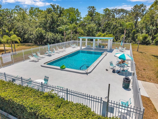 community pool featuring a patio area and fence