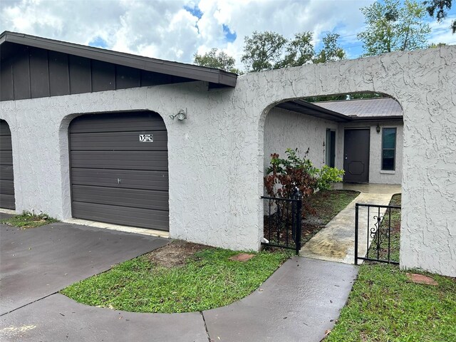 1309 Malone Ave, Spring Hill, FL 34606 - entrance to property featuring a gate and stucco siding