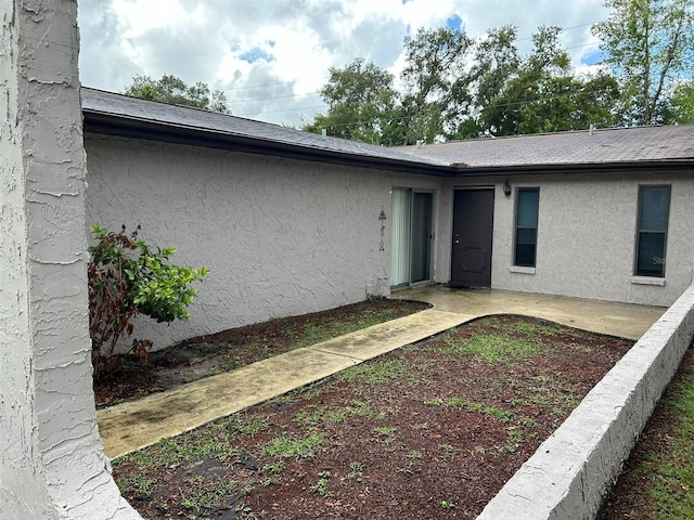 1309 Malone Ave, Spring Hill, FL 34606 - doorway to property with a patio and stucco siding